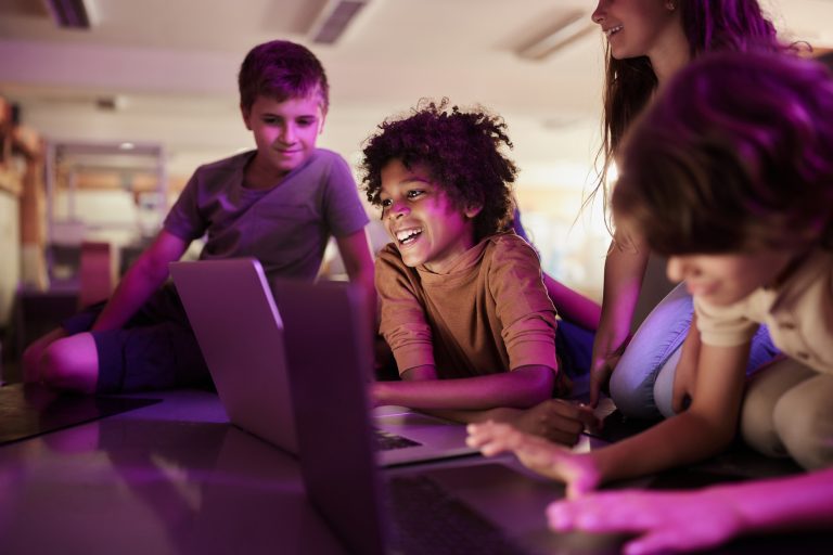 Group of young people working on computers during a class